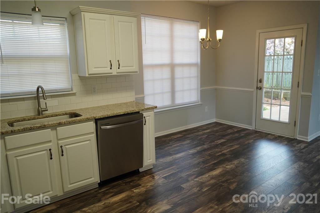 15220 Leslie Brooke Road Huntersville, NC 28078 - Photo 10 of 20 a kitchen with stainless steel appliances granite countertop a sink a stove cabinets and wooden floor