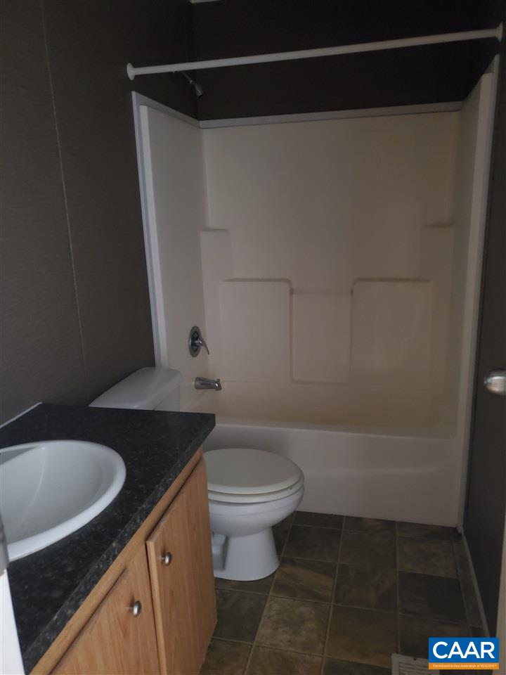3454 Firehouse Road Howardsville, VA 24562 - Photo 7 of 9 a bathroom with a sink a toilet and a shower