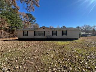 a view of a house with a large window and wooden fence
