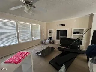 a living room with furniture windows and a flat screen tv