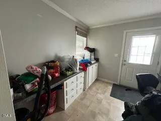 a bedroom with furniture a baby crib and a window