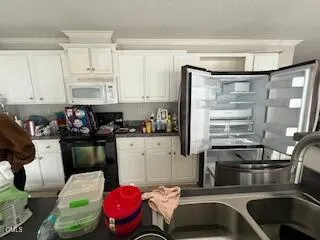 a kitchen with a refrigerator and a sink