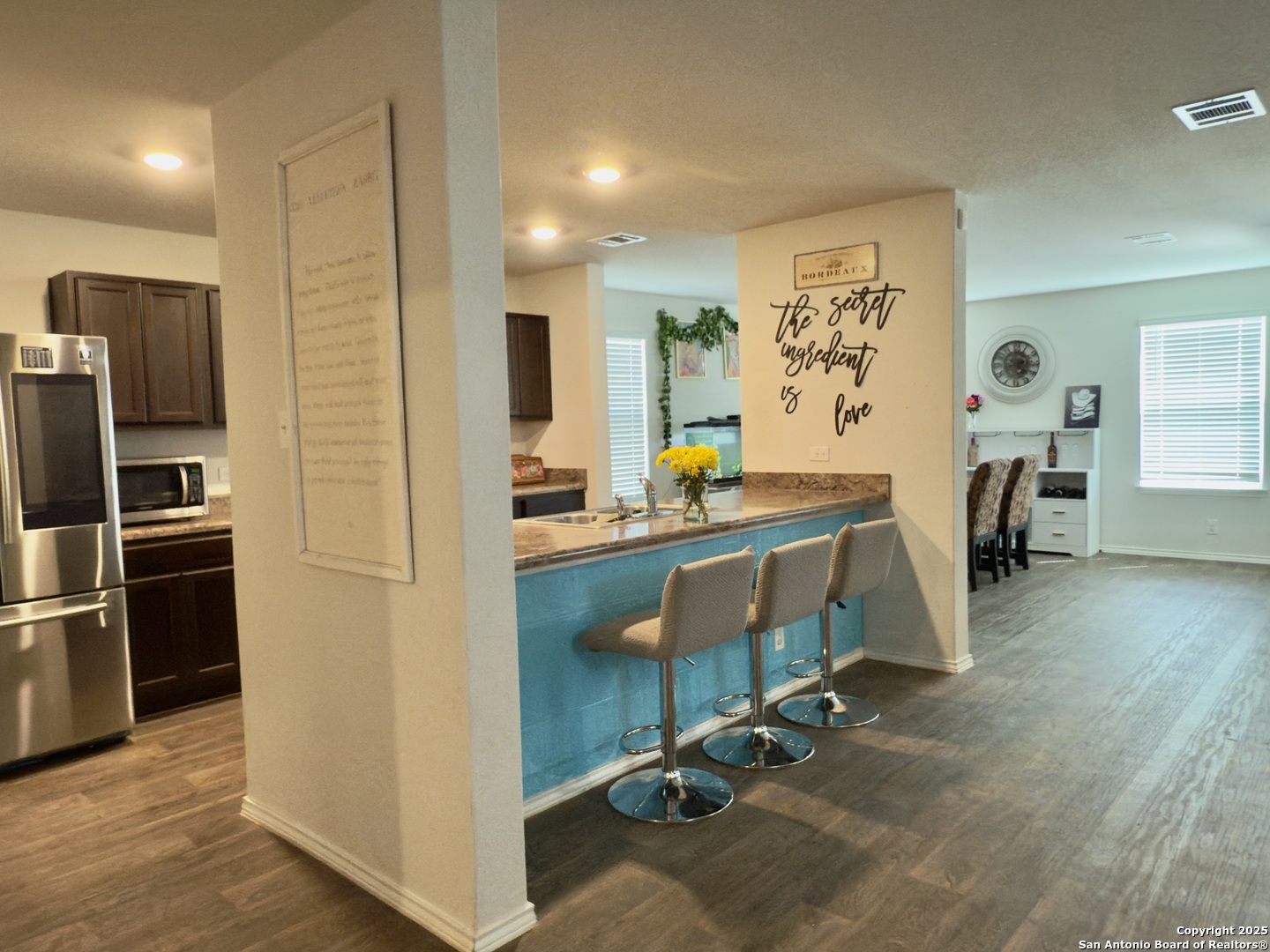 4002 Winterfell Pass Converse, TX 78109 - Photo 12 of 35 a room with stainless steel appliances kitchen island granite countertop furniture and a refrigerator