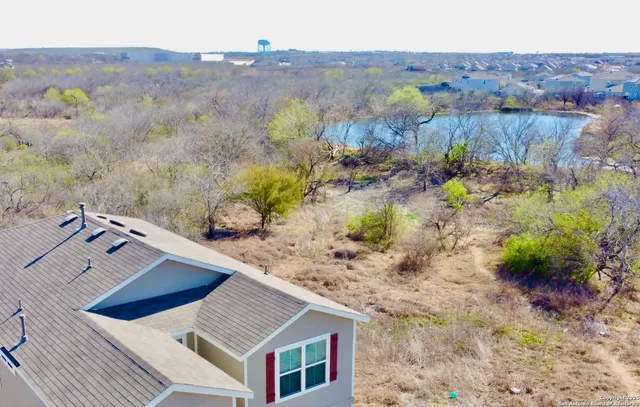 an aerial view of a house with a yard