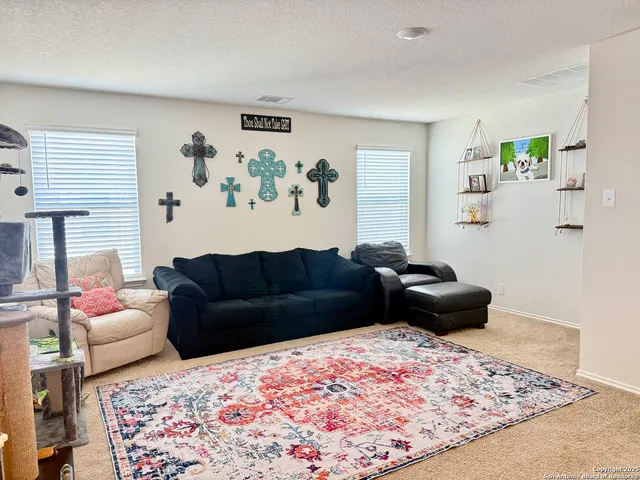 a living room with furniture and a rug