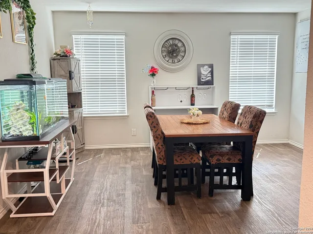 a view of a dining room with furniture window and wooden floor