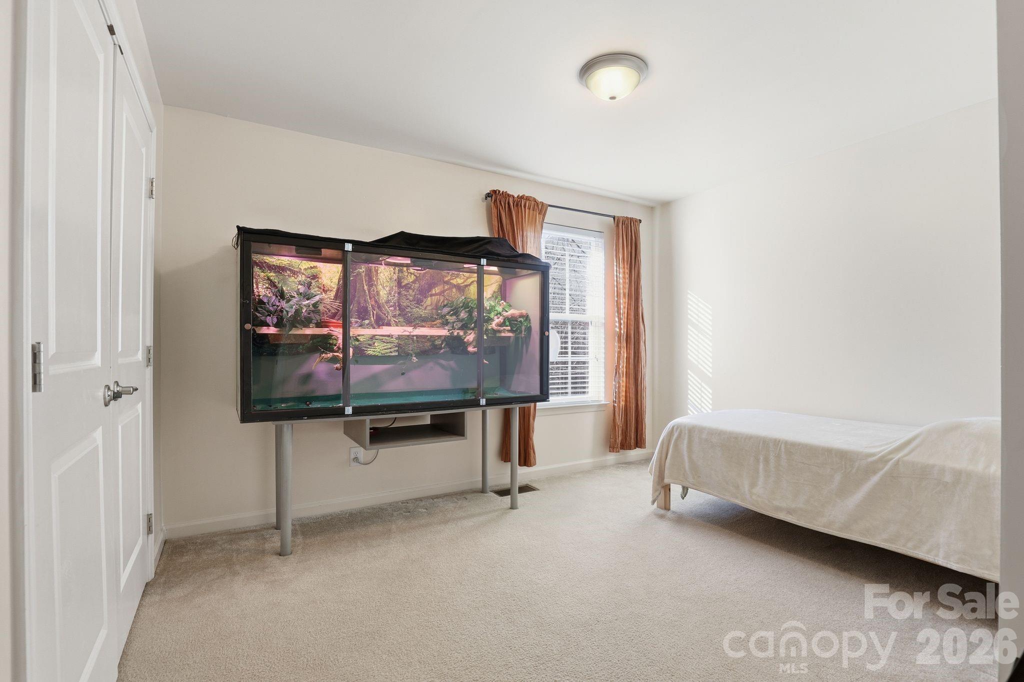 7532 West Berkeley Road, Unit 25 Denver, NC 28037 - Photo 14 of 36 a living room with furniture and a flat screen tv