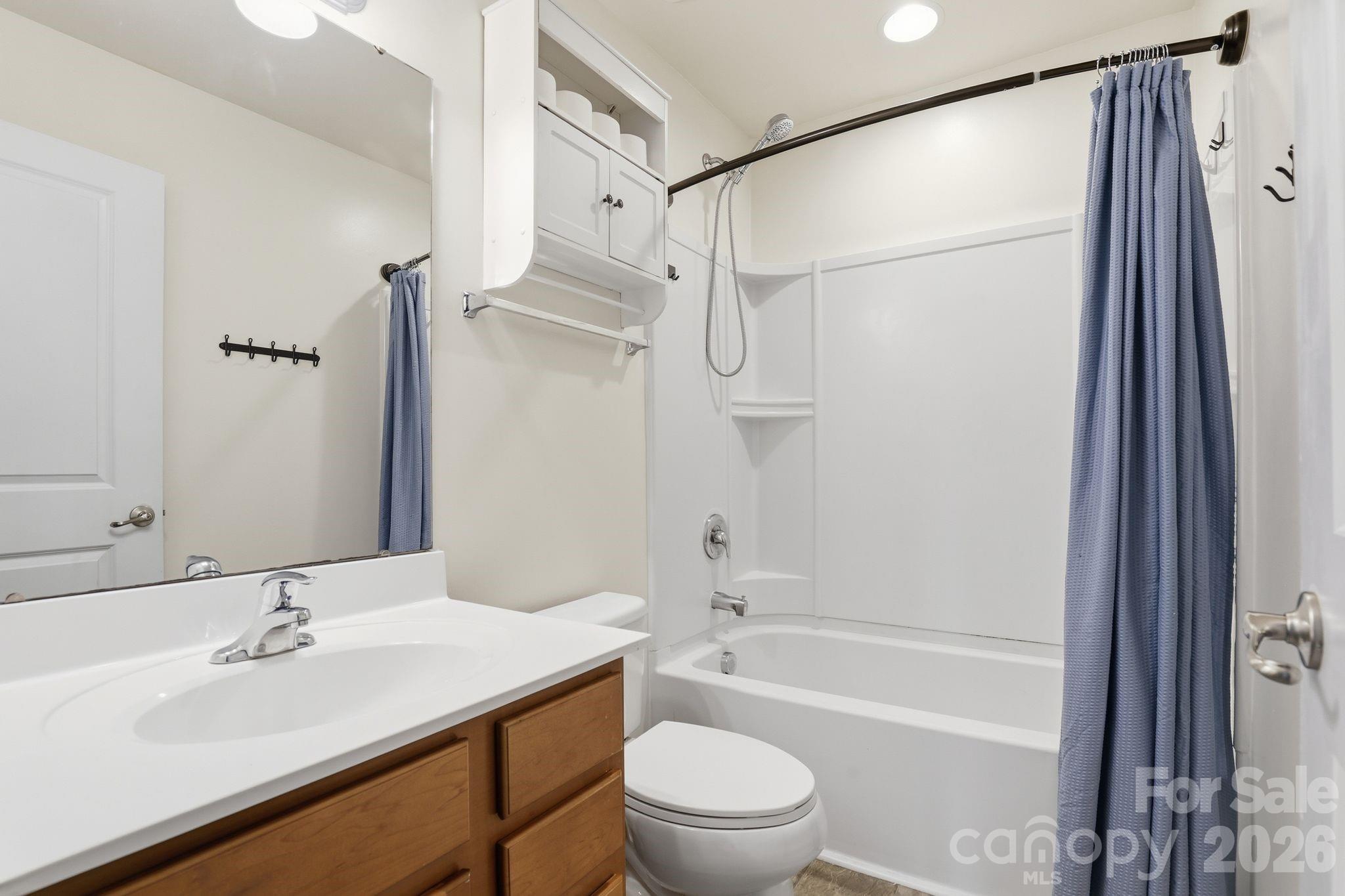 7532 West Berkeley Road, Unit 25 Denver, NC 28037 - Photo 15 of 36 a bathroom with a sink toilet tub and shower