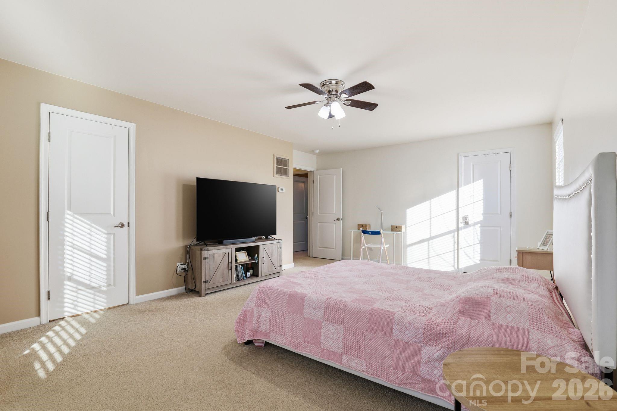 7532 West Berkeley Road, Unit 25 Denver, NC 28037 - Photo 18 of 36 a bedroom with a bed and a flat screen tv