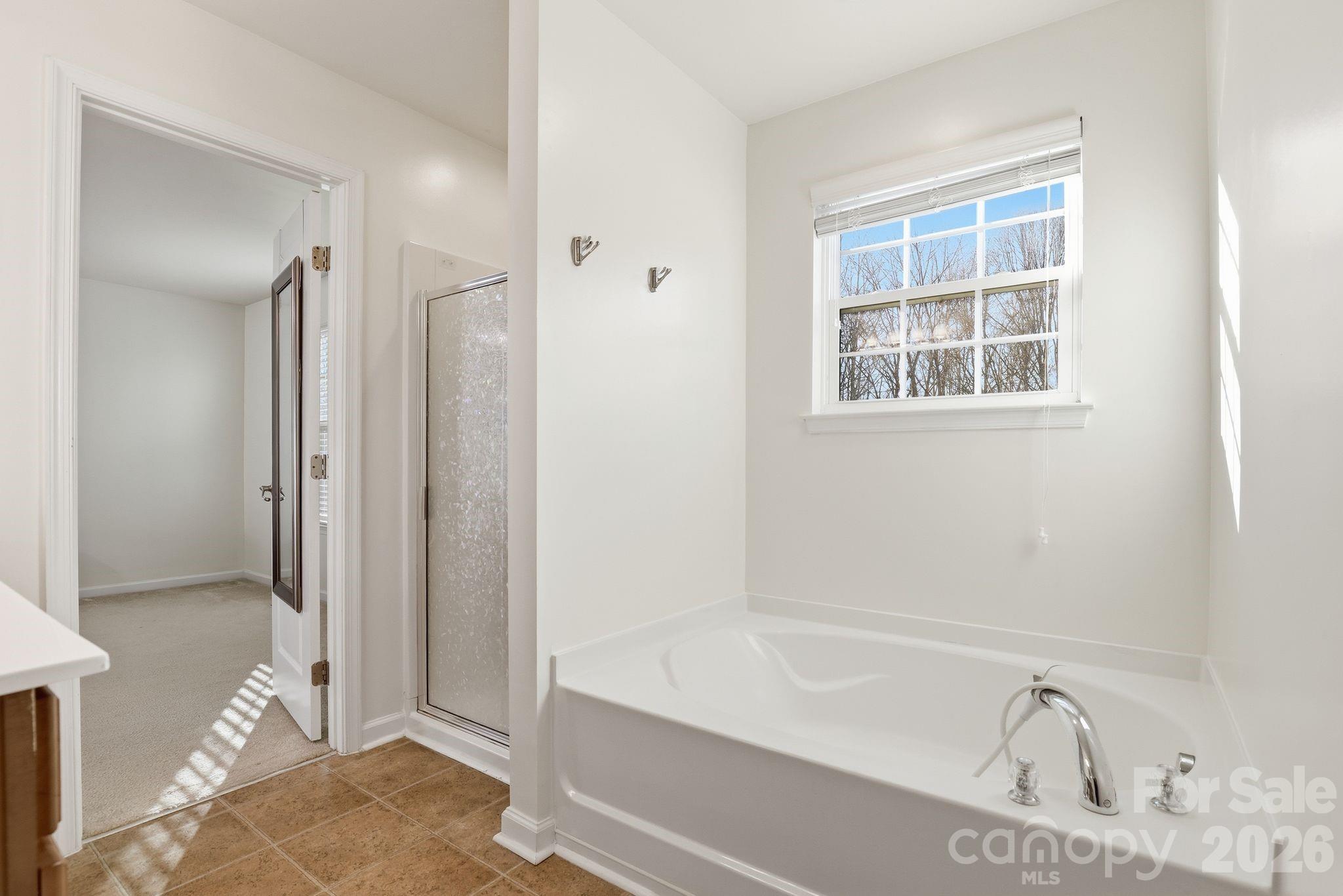 7532 West Berkeley Road, Unit 25 Denver, NC 28037 - Photo 20 of 36 a bathroom with a bathtub and a shower