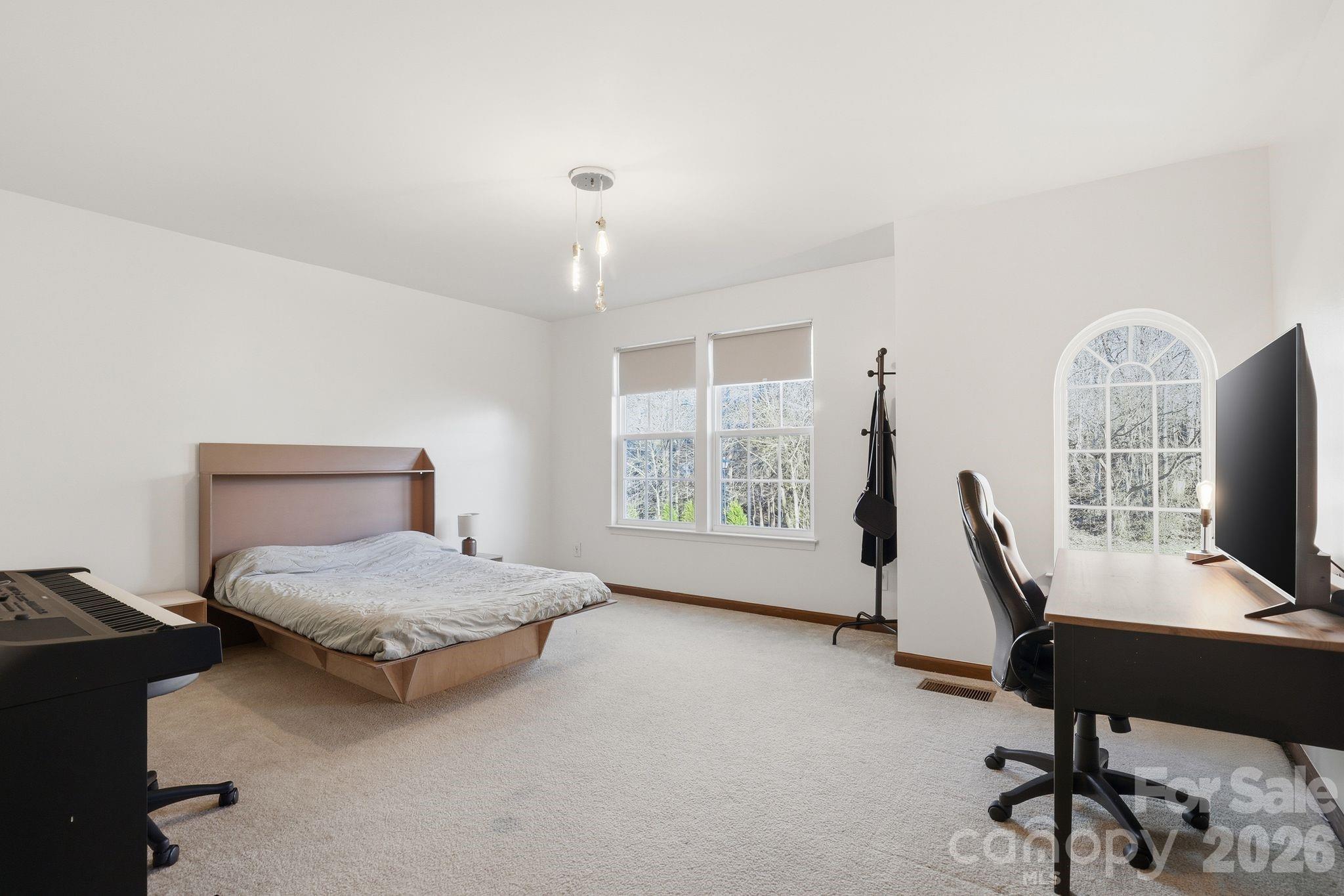7532 West Berkeley Road, Unit 25 Denver, NC 28037 - Photo 24 of 36 a bedroom with furniture and a window