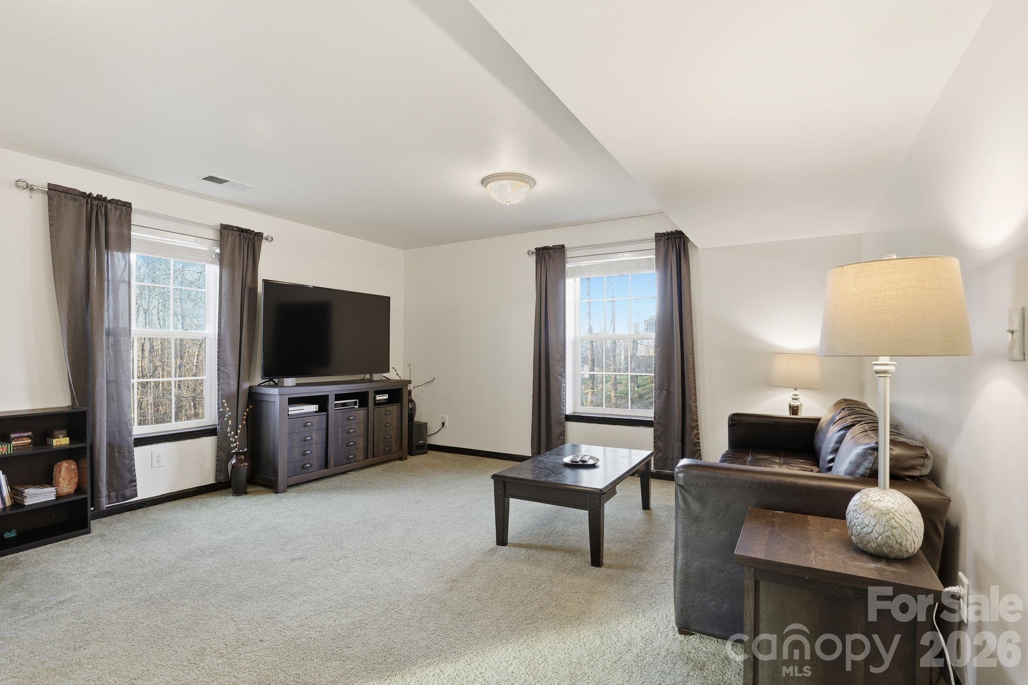 7532 West Berkeley Road, Unit 25 Denver, NC 28037 - Photo 27 of 36 a living room with furniture and a flat screen tv