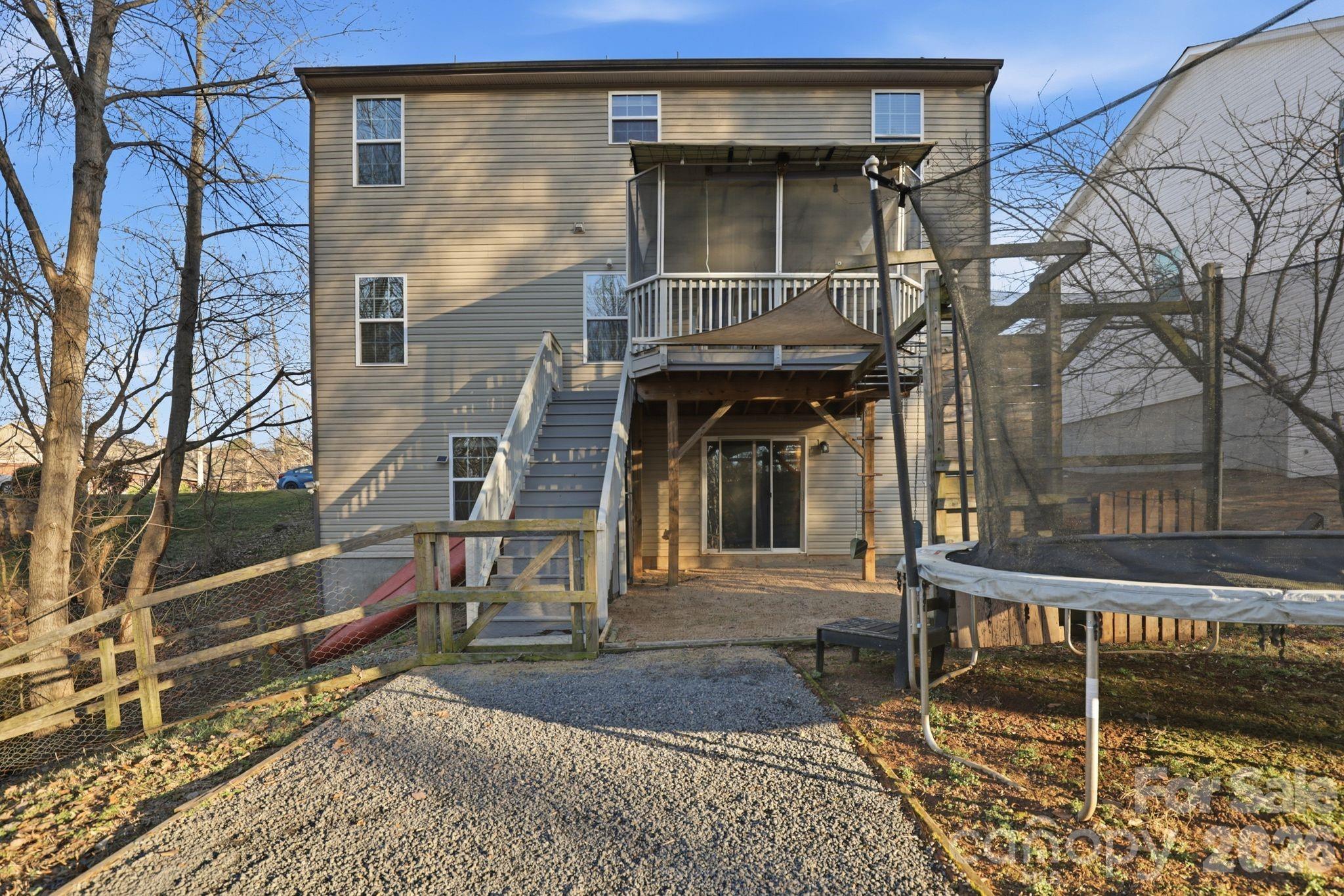7532 West Berkeley Road, Unit 25 Denver, NC 28037 - Photo 32 of 36 a view of a brick house with many windows next to a yard