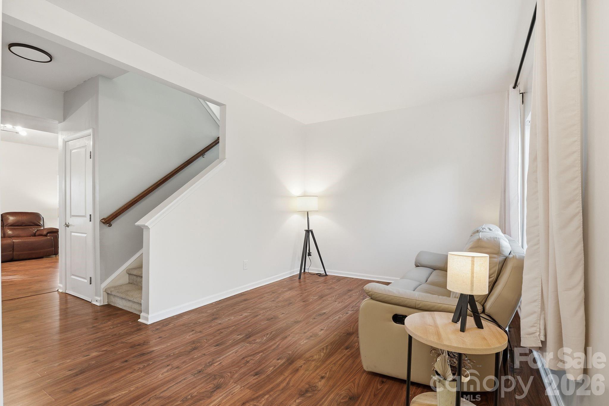 7532 West Berkeley Road, Unit 25 Denver, NC 28037 - Photo 4 of 36 a workspace with furniture and wooden floor