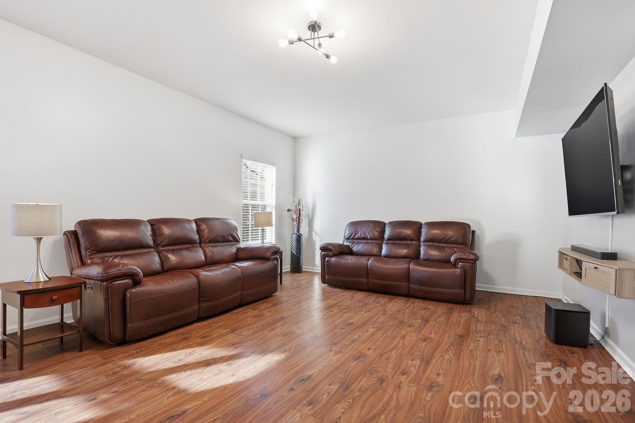 7532 West Berkeley Road, Unit 25 Denver, NC 28037 - Photo 6 of 36 a living room with furniture and a flat screen tv