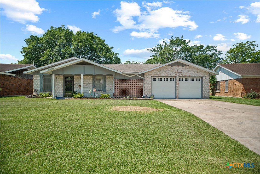 519 Travis Street Port Lavaca, TX 77979 - Photo 1 of 26 a front view of a house with a garden