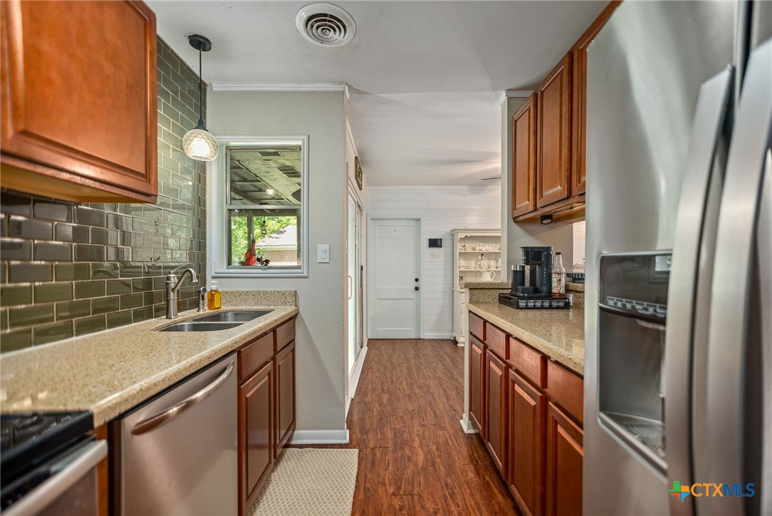 519 Travis Street Port Lavaca, TX 77979 - Photo 11 of 26 a kitchen with a sink stove and refrigerator