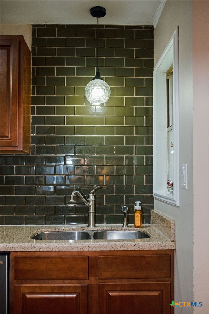 519 Travis Street Port Lavaca, TX 77979 - Photo 12 of 26 a bathroom with a sink a mirror and shower