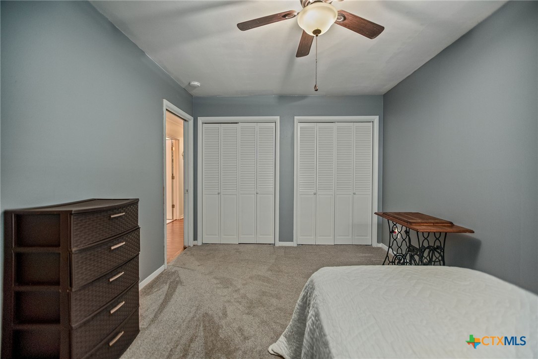 519 Travis Street Port Lavaca, TX 77979 - Photo 14 of 26 a bedroom with a bed and a dresser