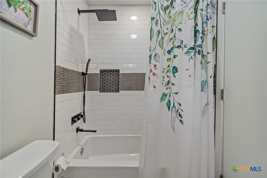519 Travis Street Port Lavaca, TX 77979 - Photo 16 of 26 a bathroom with a bathtub and shower
