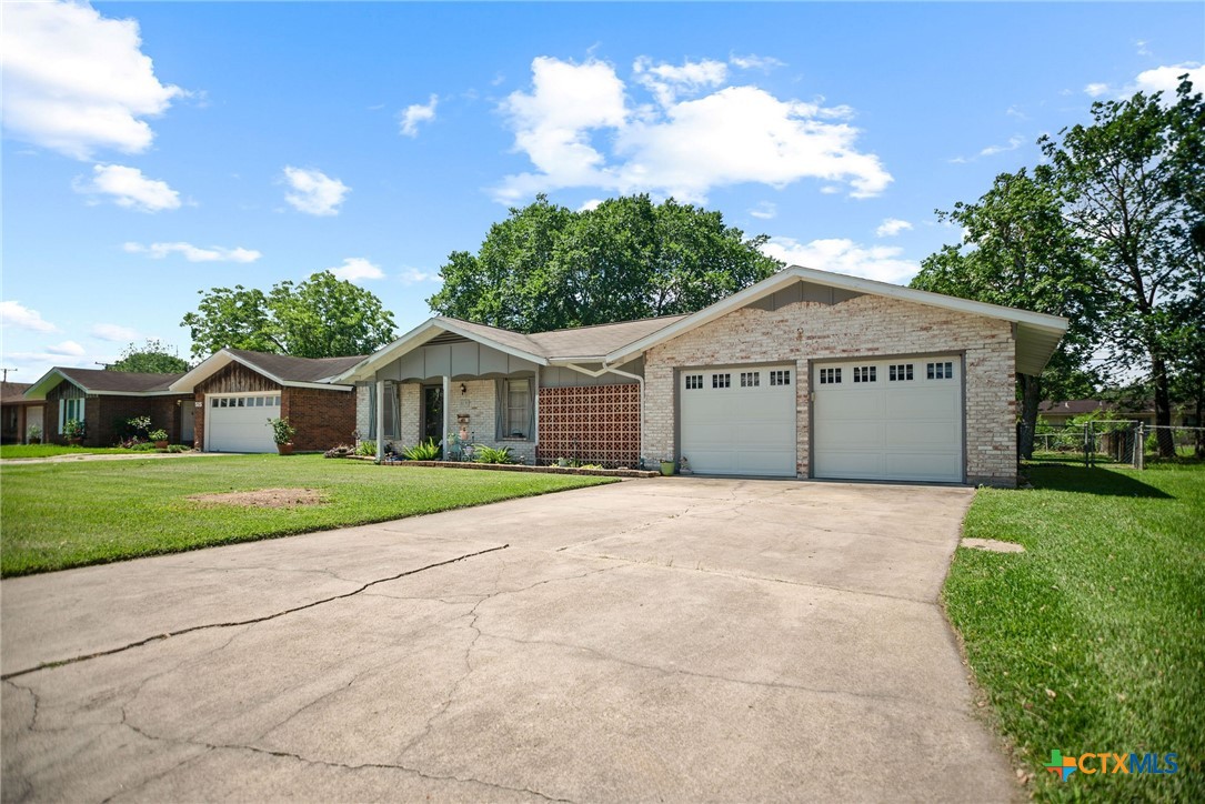 519 Travis Street Port Lavaca, TX 77979 - Photo 2 of 26 a front view of a house with a yard and garage