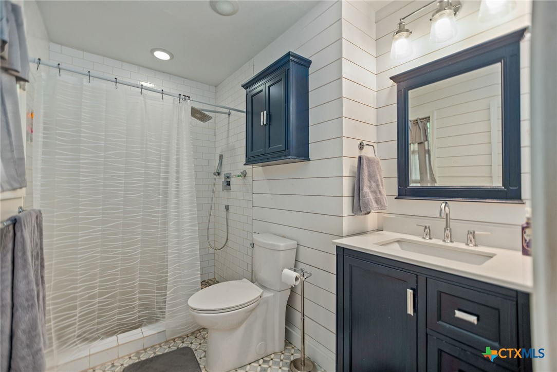 519 Travis Street Port Lavaca, TX 77979 - Photo 21 of 26 a bathroom with a sink toilet and shower