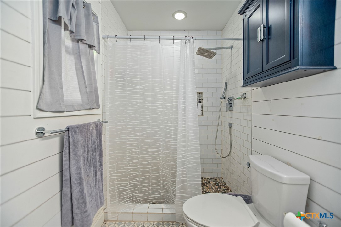 519 Travis Street Port Lavaca, TX 77979 - Photo 22 of 26 a bathroom with a toilet and shower