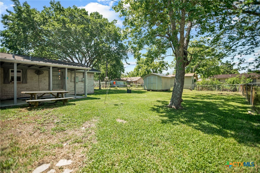 519 Travis Street Port Lavaca, TX 77979 - Photo 25 of 26 a view of a backyard with large trees