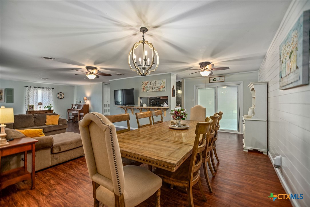519 Travis Street Port Lavaca, TX 77979 - Photo 8 of 26 a view of a dining room with furniture a chandelier and wooden floor