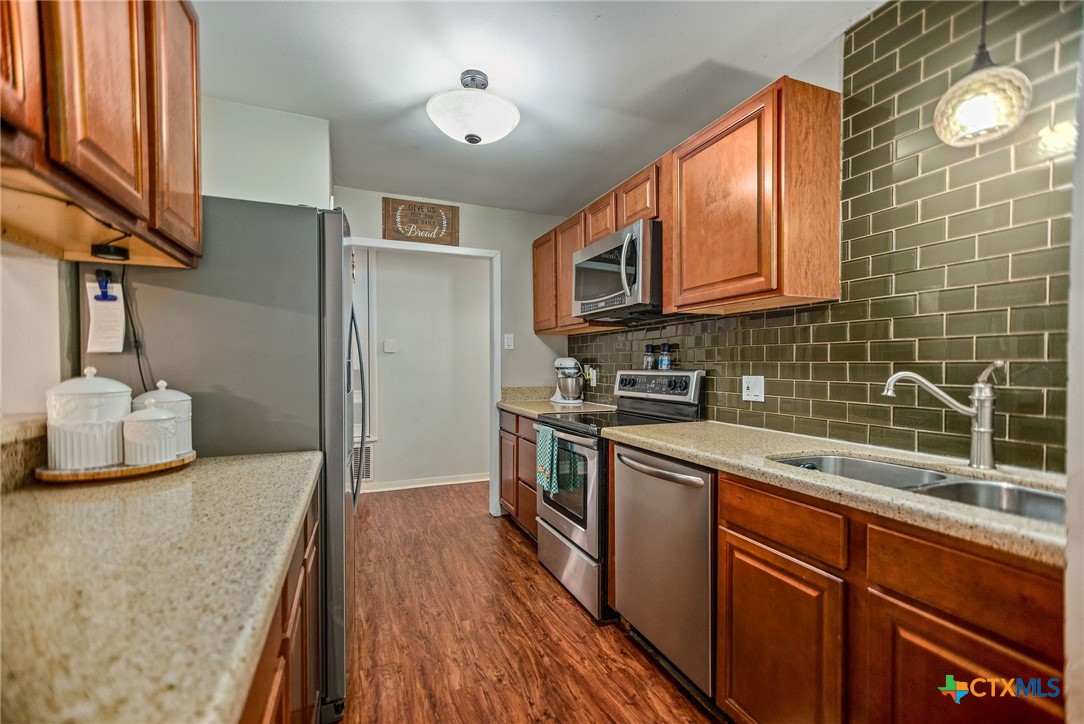 519 Travis Street Port Lavaca, TX 77979 - Photo 10 of 26 a kitchen with stainless steel appliances granite countertop a sink stove and cabinets