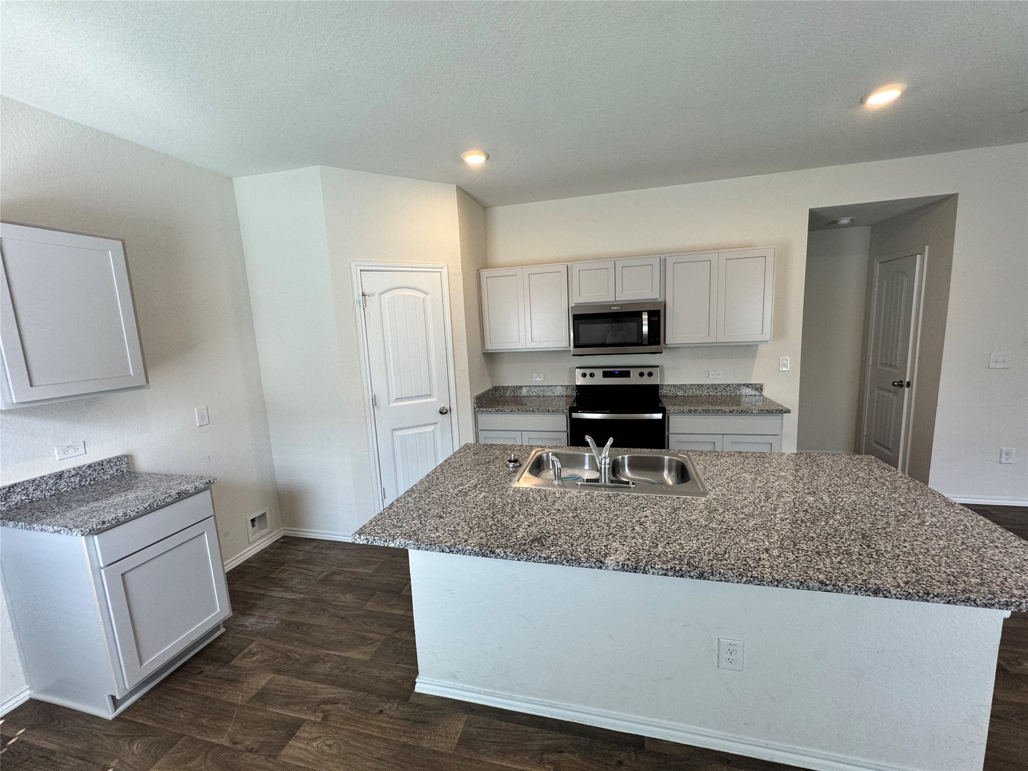 11820 Rush Lane Elgin, TX 78621 - Photo 26 of 31 A well-appointed culinary space featuring sleek cabinetry and robust granite surfaces for all your cooking needs.