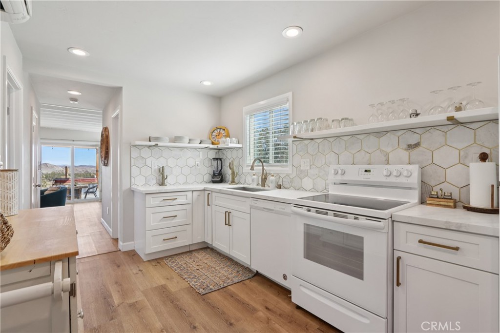 5235 Border Avenue Joshua Tree, CA 92252 - Photo 11 of 63 a kitchen with granite countertop white cabinets and white appliances