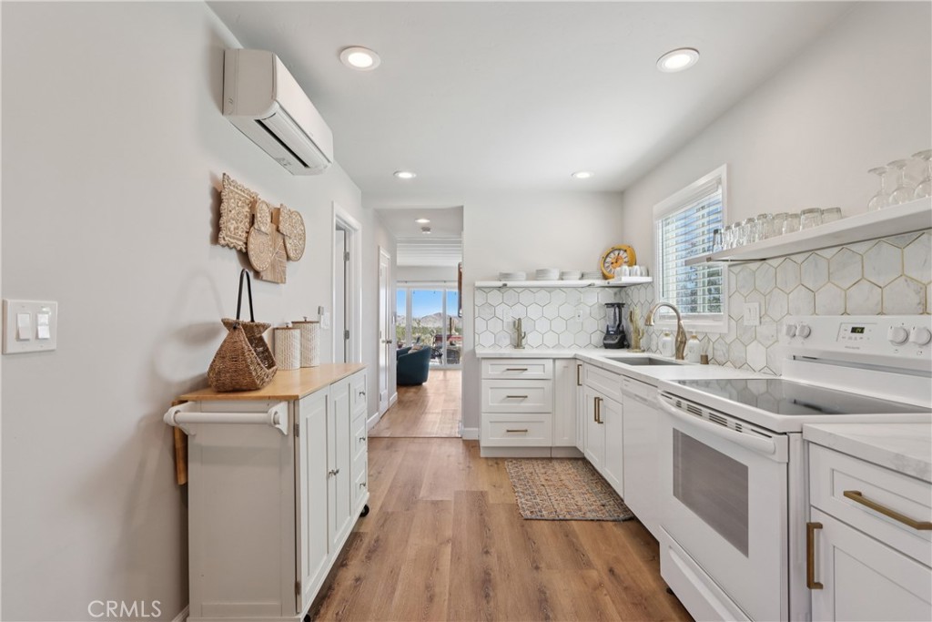 5235 Border Avenue Joshua Tree, CA 92252 - Photo 12 of 63 a kitchen with white cabinets sink and stove