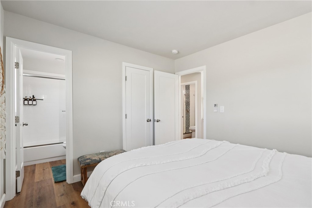 5235 Border Avenue Joshua Tree, CA 92252 - Photo 20 of 63 a bedroom with a bed and wooden floor