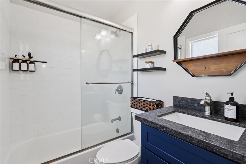 5235 Border Avenue Joshua Tree, CA 92252 - Photo 21 of 63 a bathroom with a granite countertop sink and a mirror