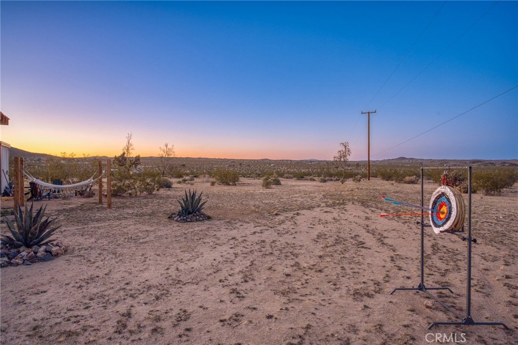 5235 Border Avenue Joshua Tree, CA 92252 - Photo 29 of 63 a view of a dry field with sunset in background