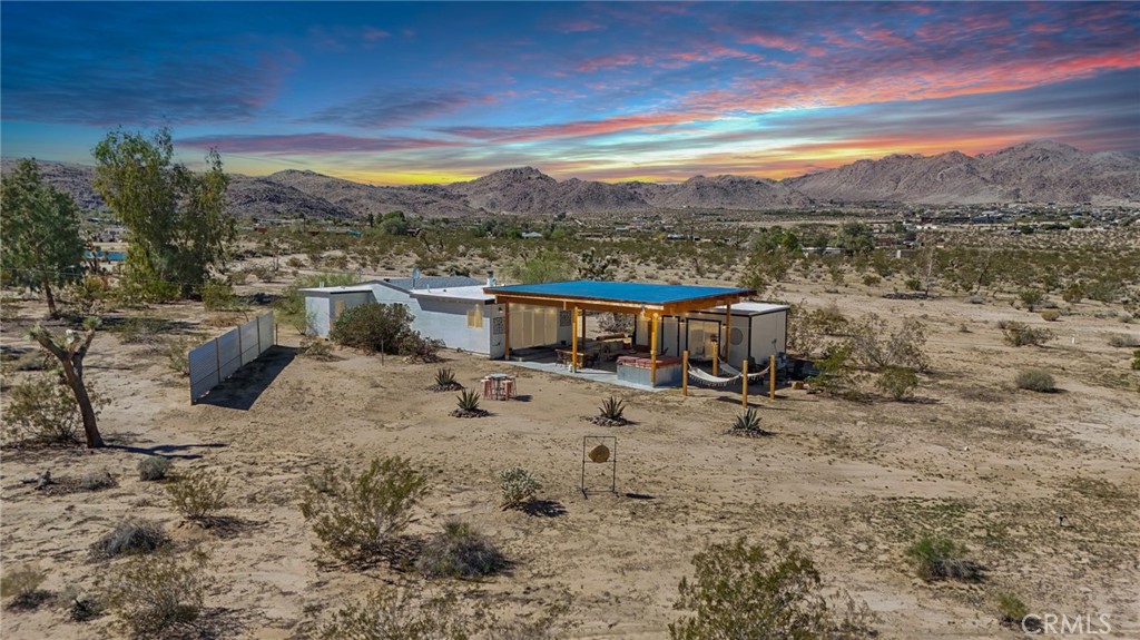 5235 Border Avenue Joshua Tree, CA 92252 - Photo 3 of 63 a view of a terrace with a table and chairs