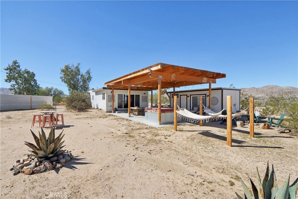 5235 Border Avenue Joshua Tree, CA 92252 - Photo 40 of 63 a view of a house with backyard and sitting area
