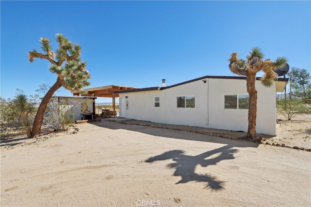 5235 Border Avenue Joshua Tree, CA 92252 - Photo 42 of 63 a view of a house with a snow in the yard