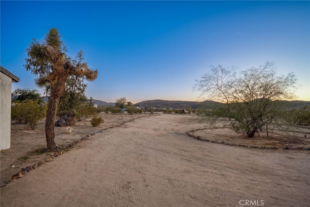 5235 Border Avenue Joshua Tree, CA 92252 - Photo 47 of 63 a view of a dry yard with wooden fence