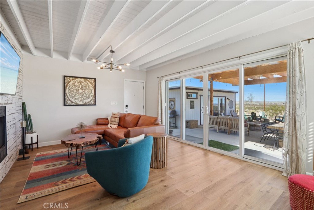5235 Border Avenue Joshua Tree, CA 92252 - Photo 8 of 63 a living room with furniture and a floor to ceiling window