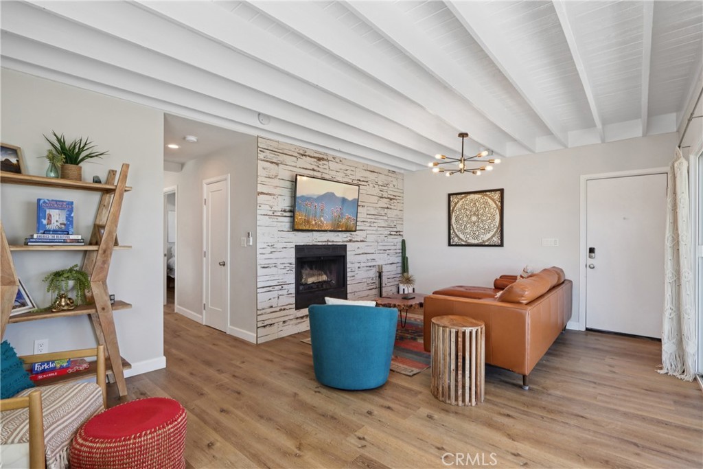 5235 Border Avenue Joshua Tree, CA 92252 - Photo 9 of 63 a living room with furniture wooden floor and a fireplace