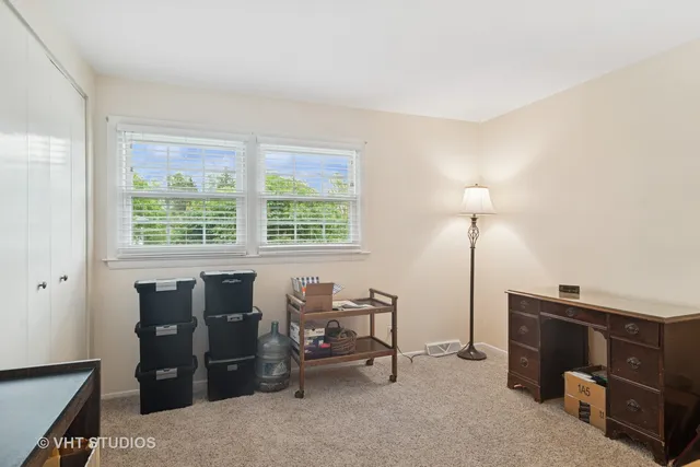 a view of a workspace with furniture and a window