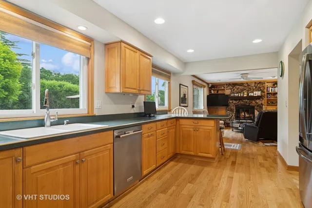 a kitchen with wooden floors and sink