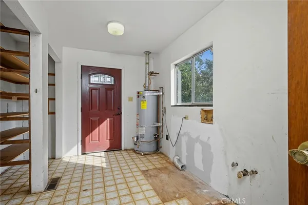 a view of a hallway with wooden floor and a living room