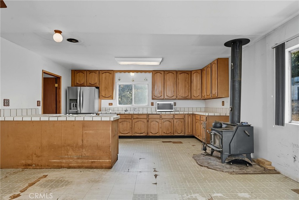 13028 Riata Road Lower Lake, CA 95457 - Photo 6 of 40 a kitchen that has a lot of cabinets in it and appliances