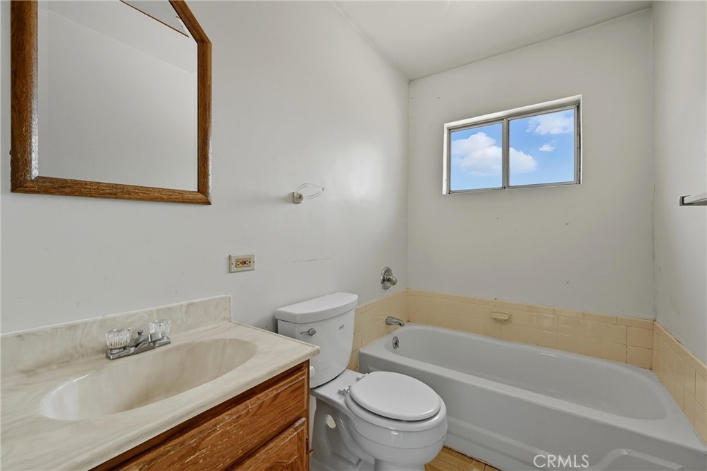 13028 Riata Road Lower Lake, CA 95457 - Photo 7 of 40 a bathroom with a granite countertop toilet a sink and bathtub