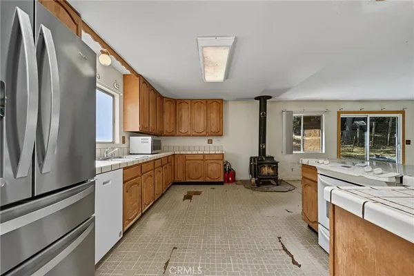 a kitchen with stainless steel appliances a refrigerator sink and cabinets