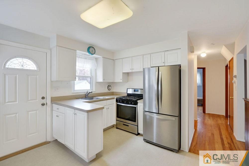 38 Montview Road Edison, NJ 08837 - Photo 12 of 25 a kitchen with a sink a refrigerator and a stove