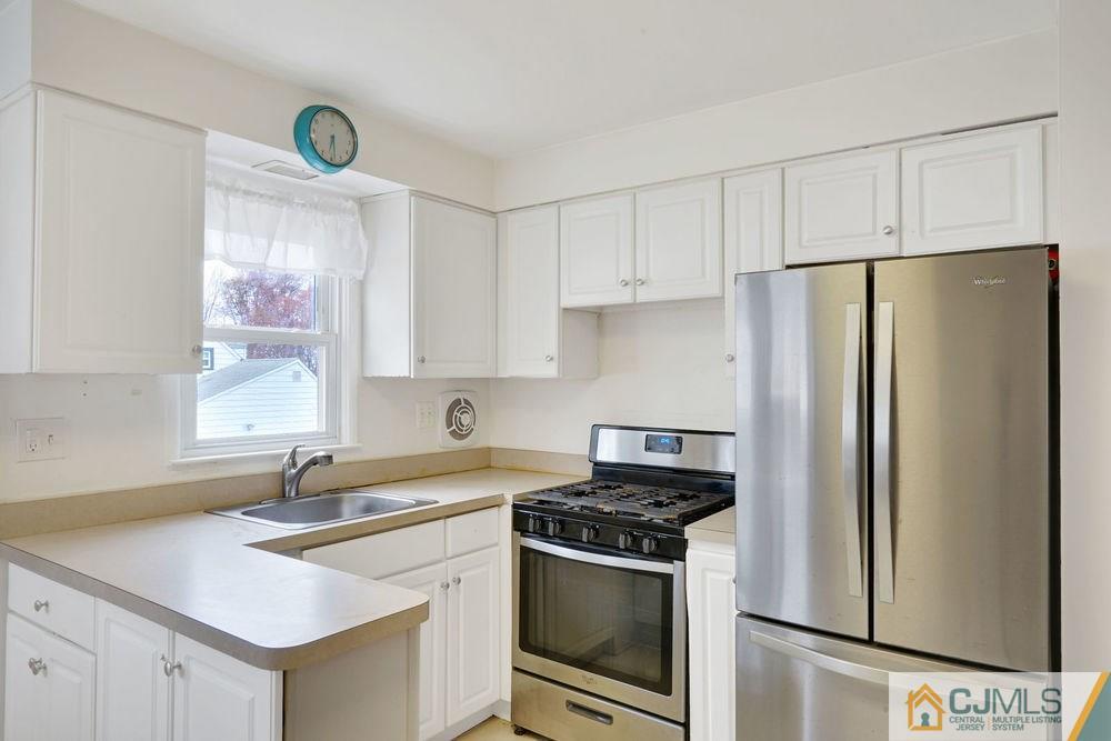 38 Montview Road Edison, NJ 08837 - Photo 13 of 25 a kitchen with stainless steel appliances a refrigerator sink and cabinets